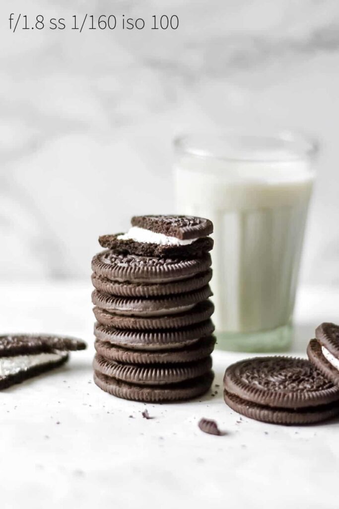a stack of oreo cookies with some milk