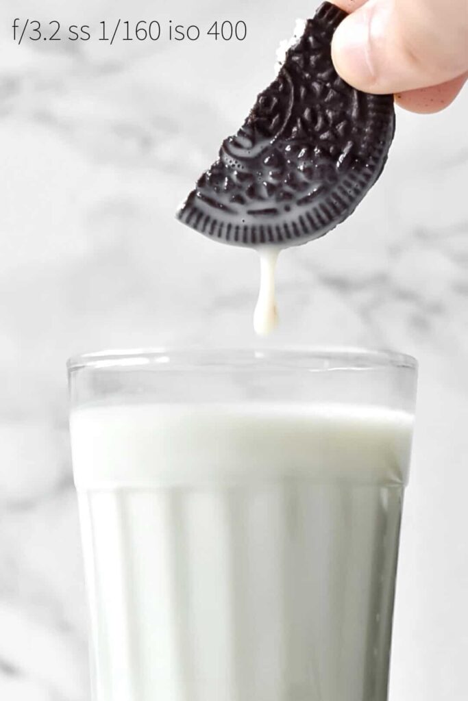 an oreo cookie with milk dripping from it