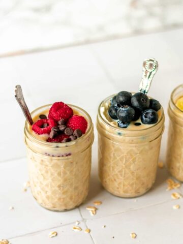 some jars of overnight oats topped with berries