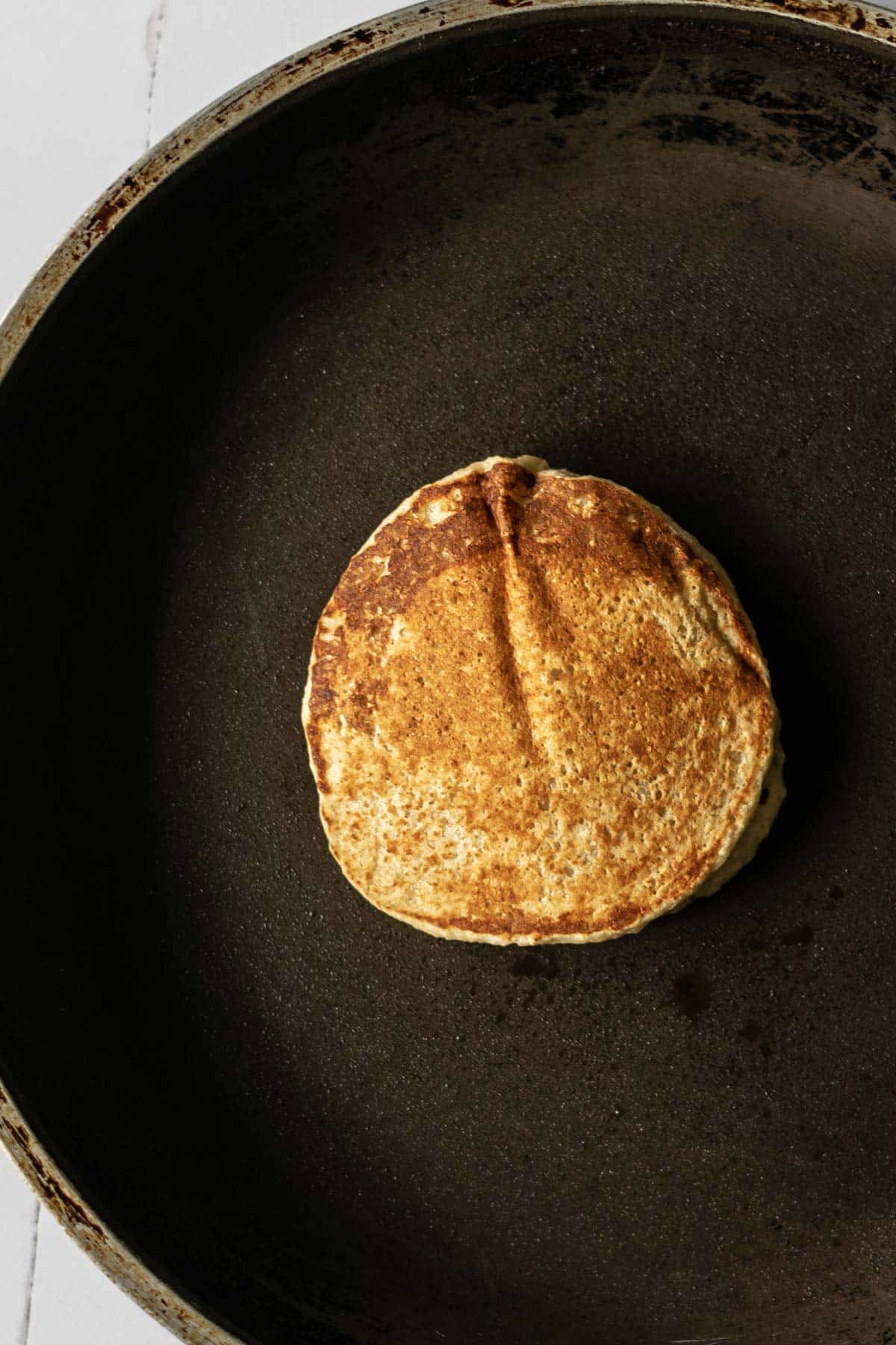 a cooked pancake in a frying pan