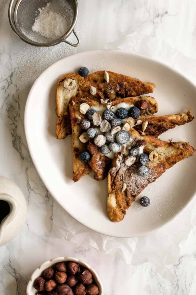 vegan French toast topped with blueberries and hazlenuts