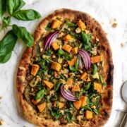 naan pizza topped with basil and sweet potato