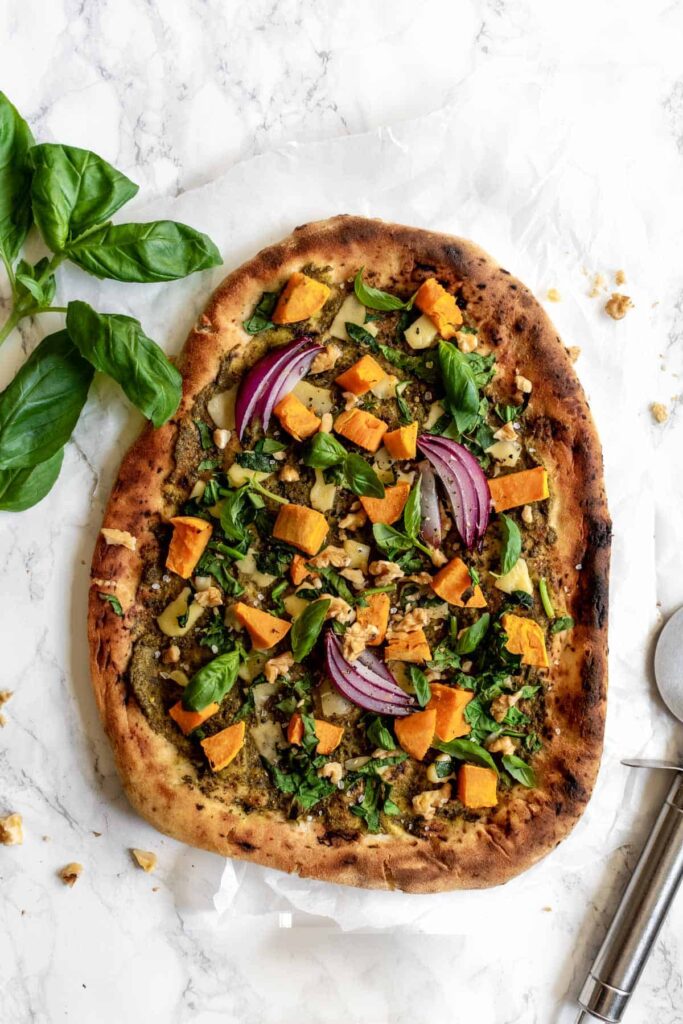 naan pizza topped with basil and sweet potato