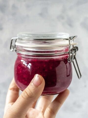 a jar of jam held up