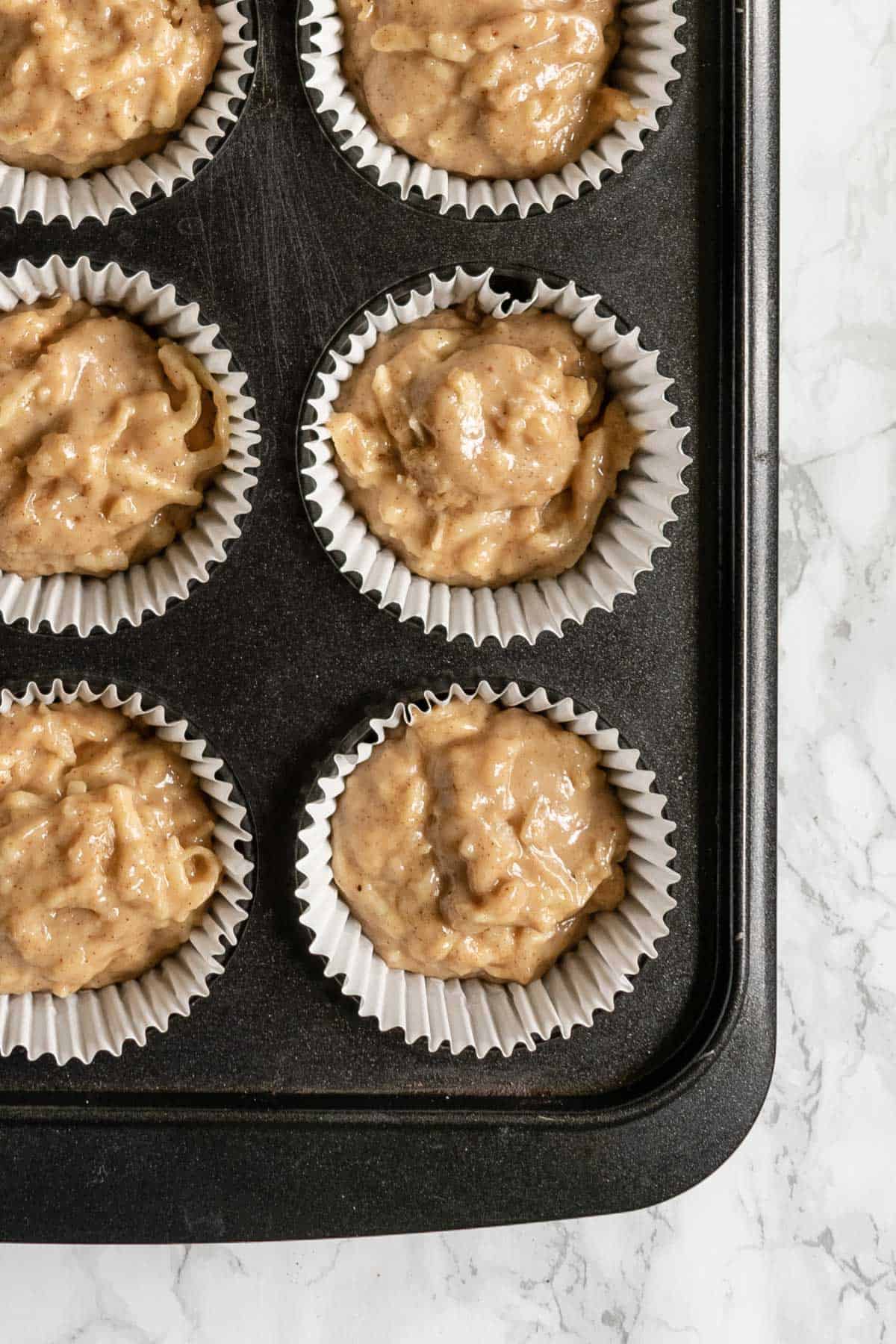 scooped out muffins in a muffin tin