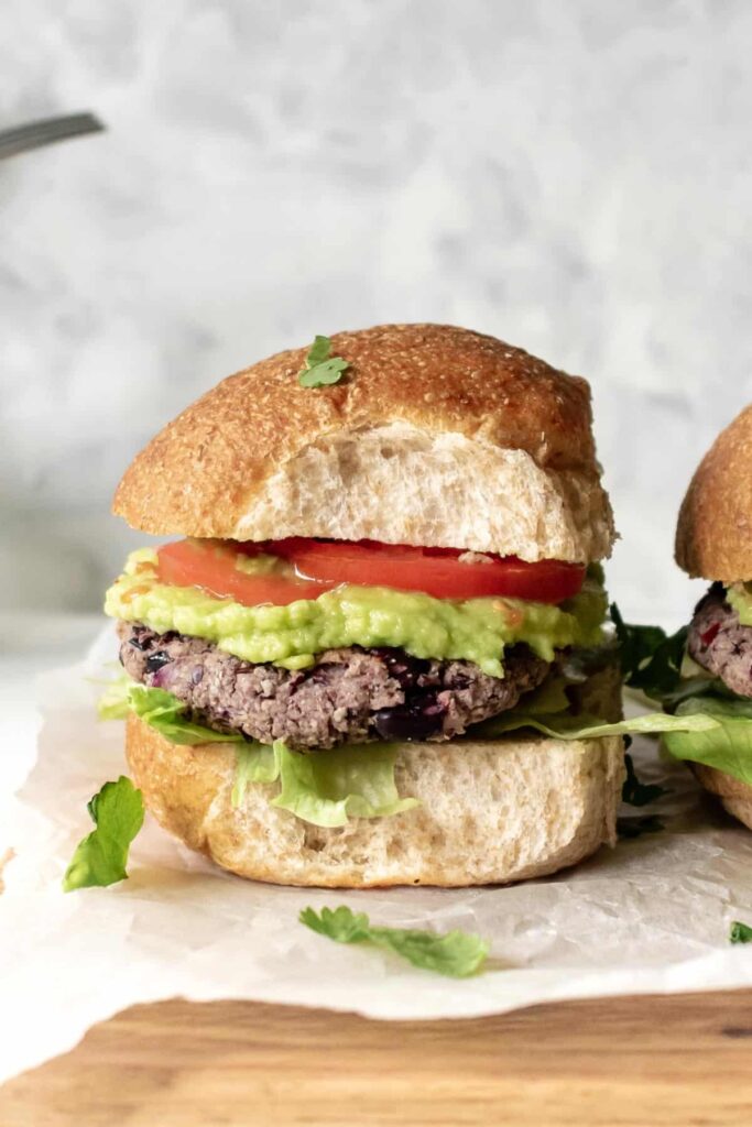 a bean burger with avocado, tomato and lettuce