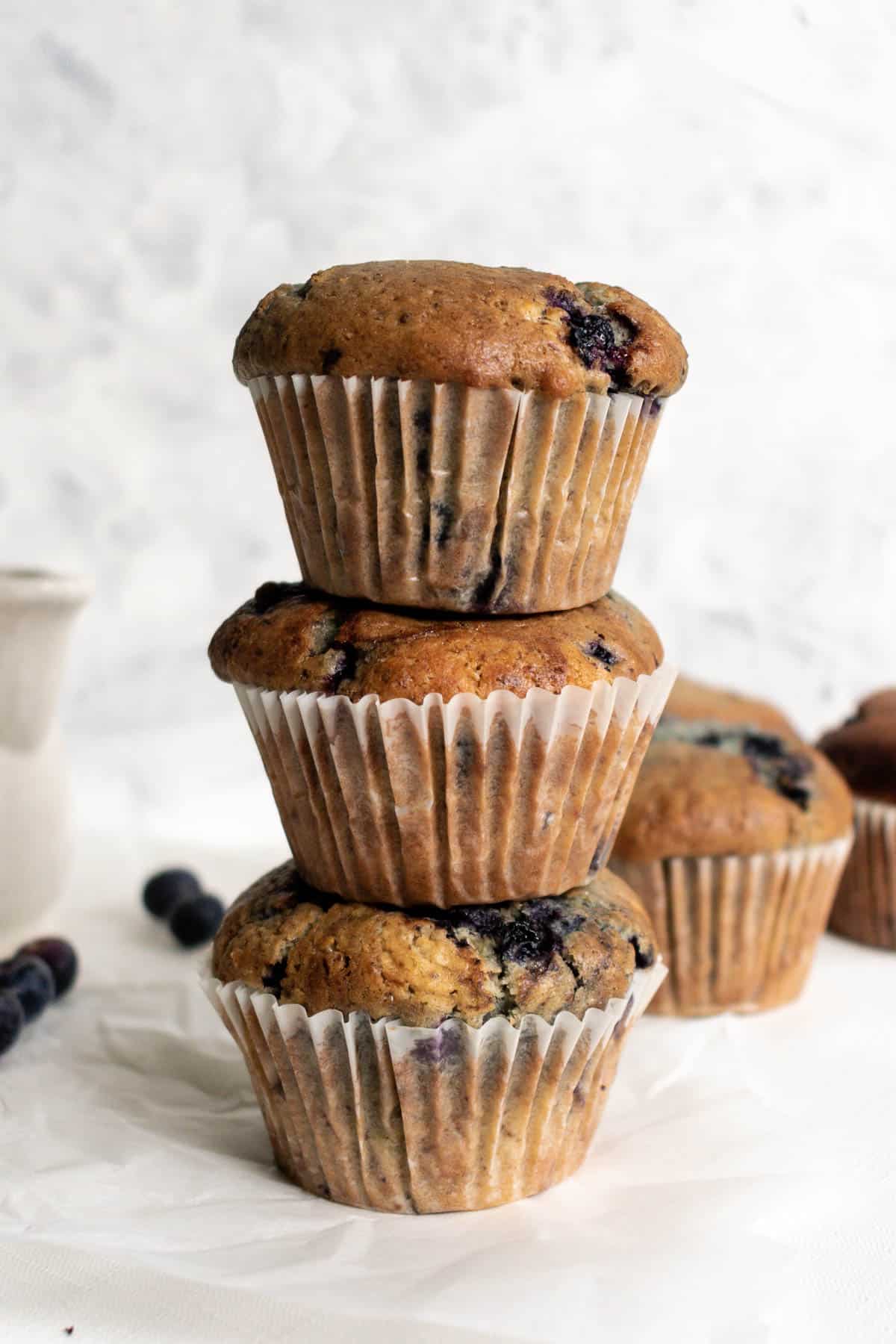 three blueberry muffins stacked on top of each other