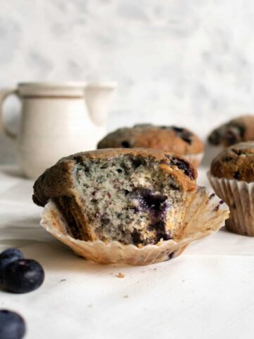 a blueberry muffin with a bite taken from it
