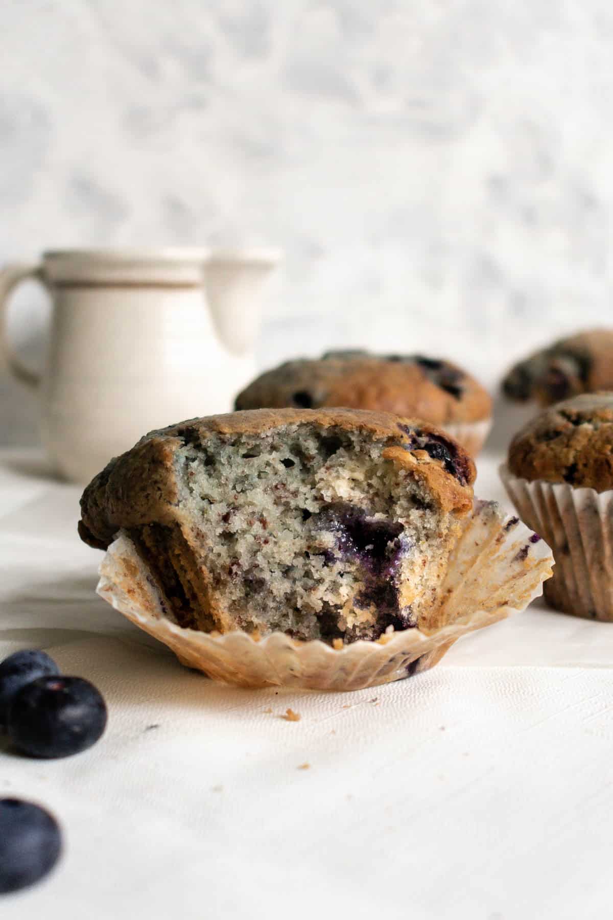a blueberry muffin with a bite taken from it