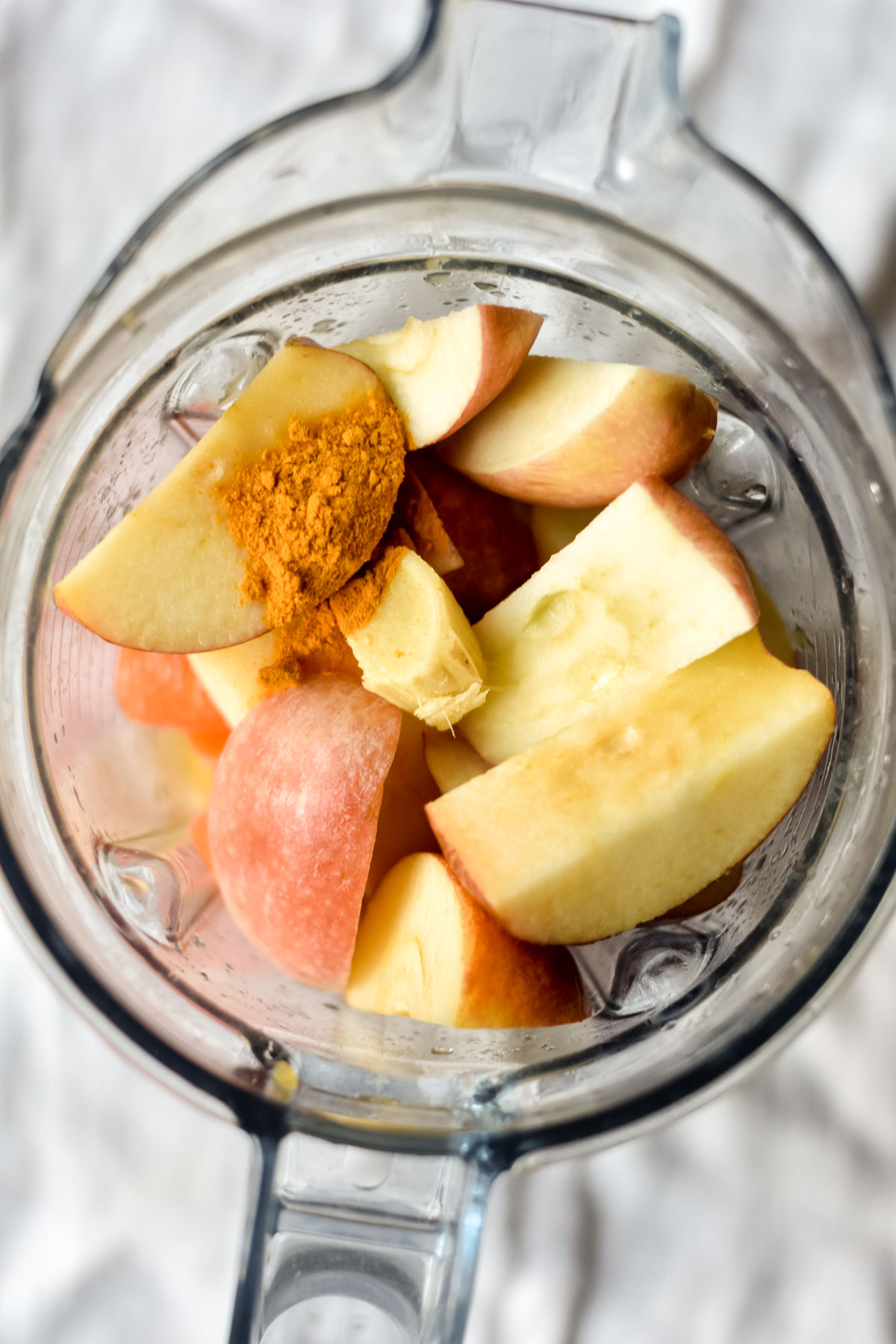 a blender full of fruit, ginger and turmeric