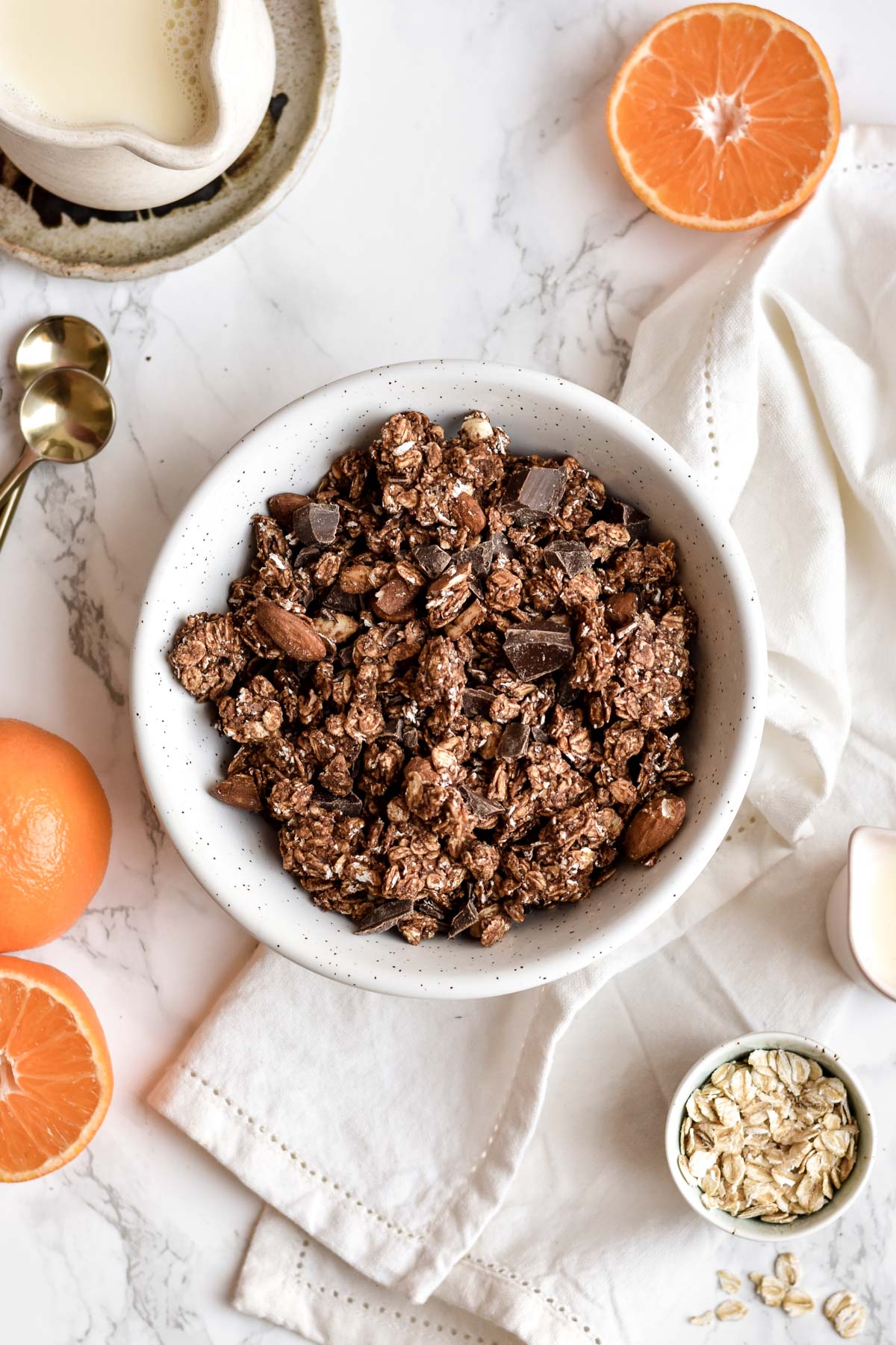 a bowl of chocolate orange granola with oranges