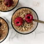 a jar of chia pudding topped with raspberries