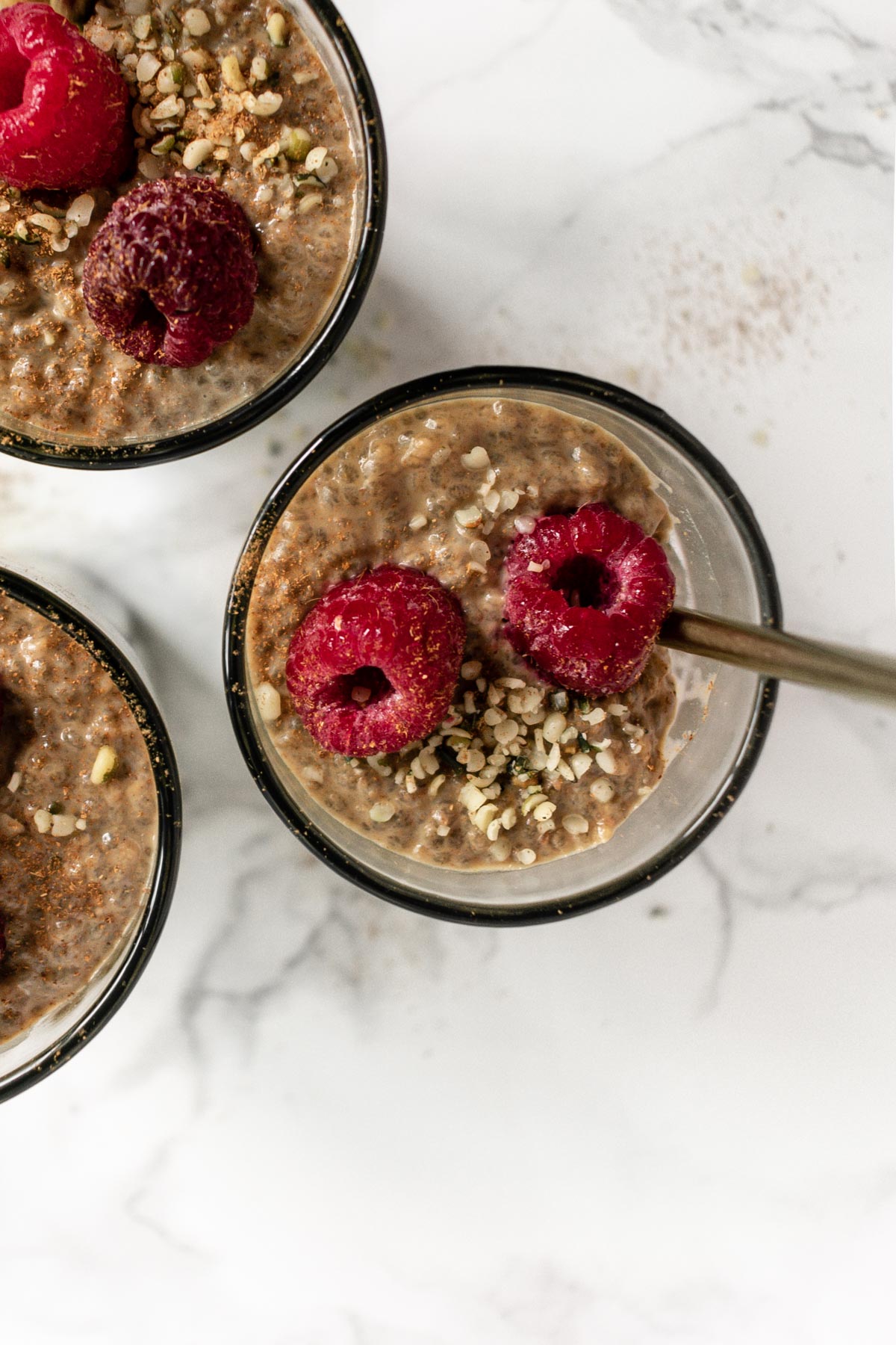 a jar of chia pudding topped with raspberries