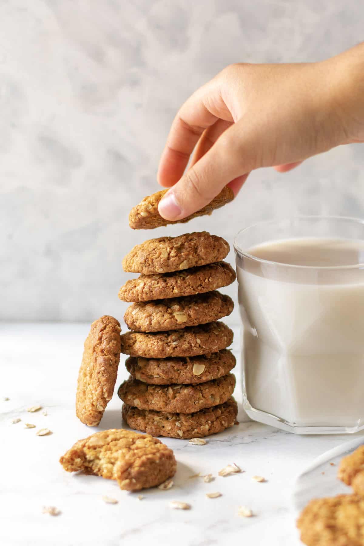 a stack of cookies next to a glass of milk