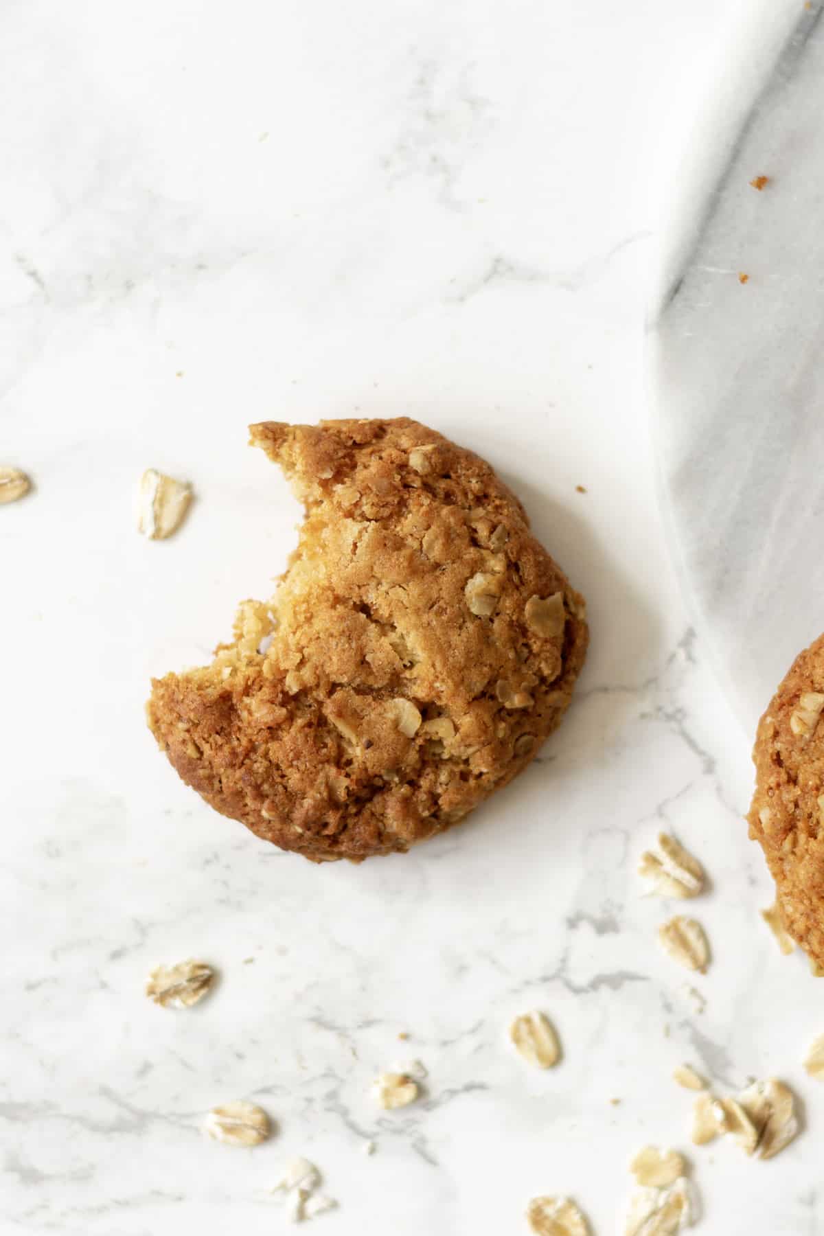 an oatmeal cookie with a bite taken from it