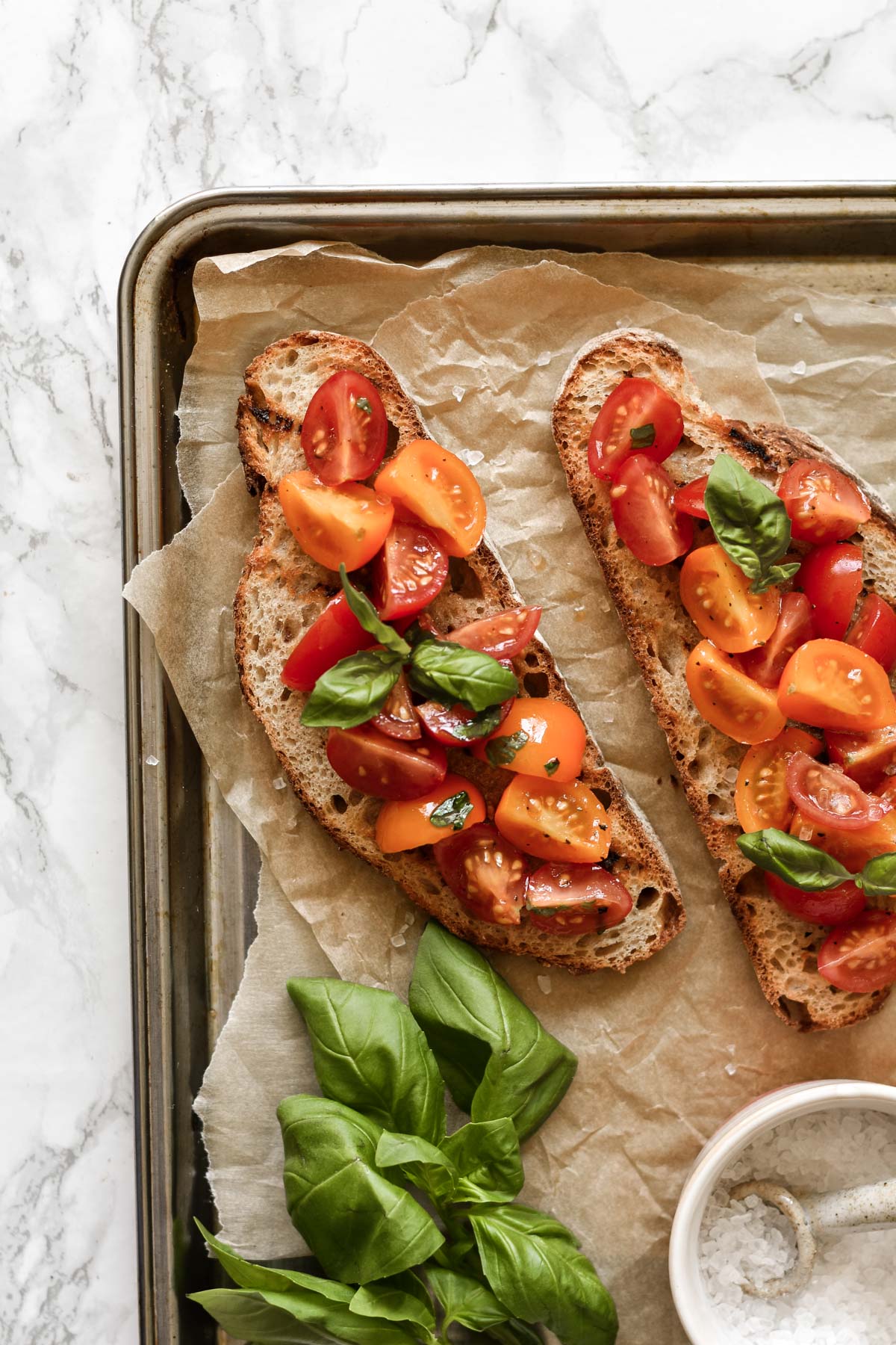 two slices of bruschetta topped with basil