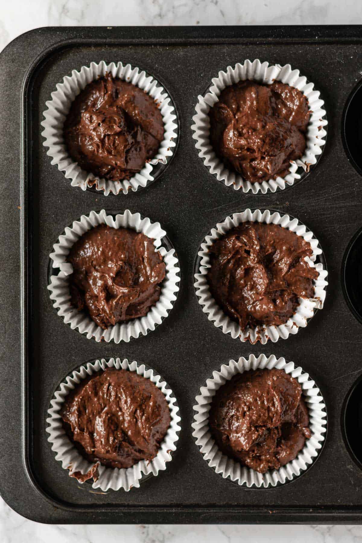 cupcake cases filled with chocolate batter