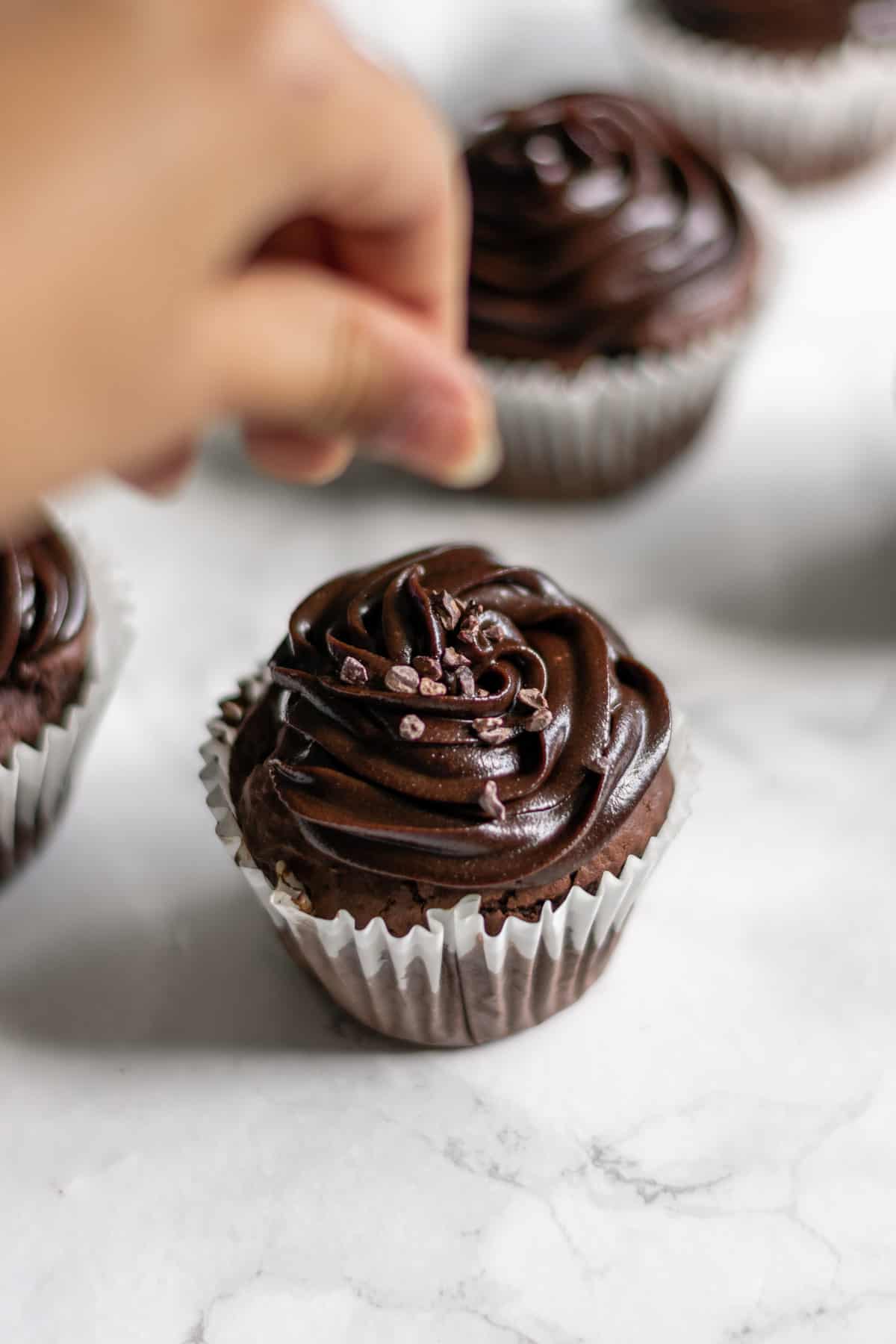 chocolate cupcakes being decorated