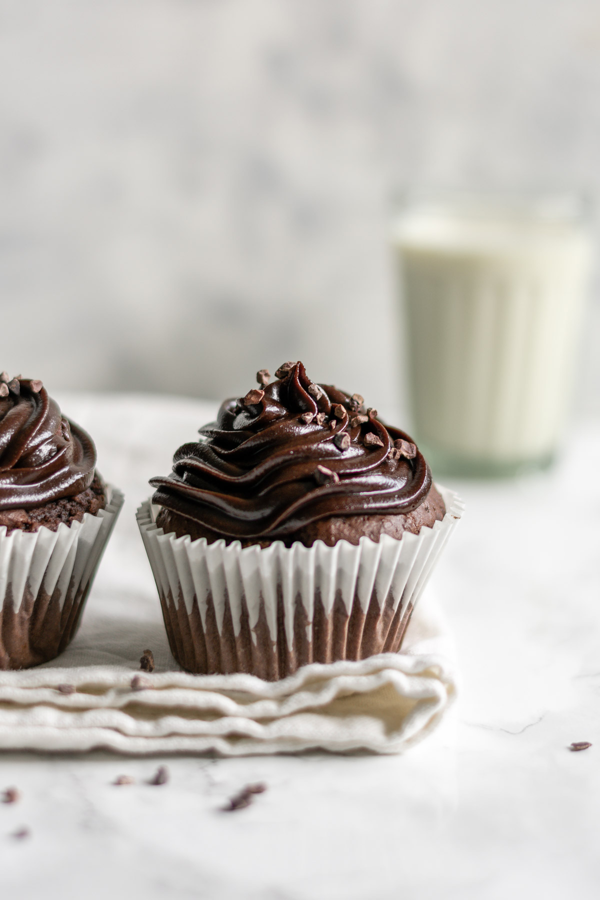 a chocolate cupcake and a glass of milk