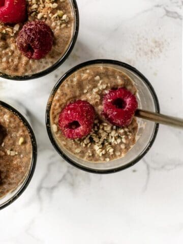 a jar of chia pudding topped with raspberries
