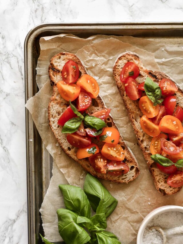 two slices of bruschetta topped with basil