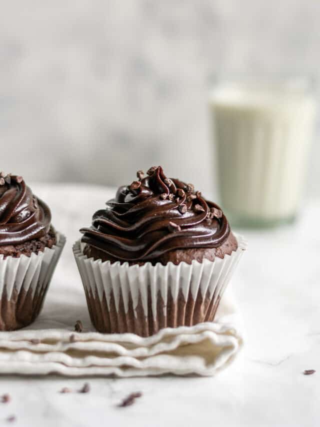 a chocolate cupcake and a glass of milk