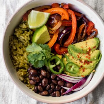 a burrito bowl with vegetables and avocado