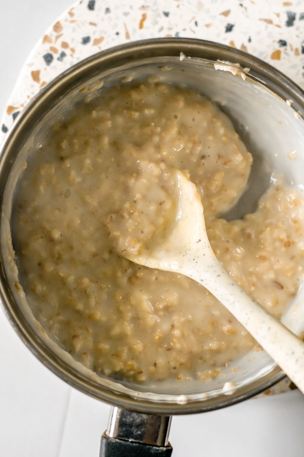 a pot of oatmeal with a spoon
