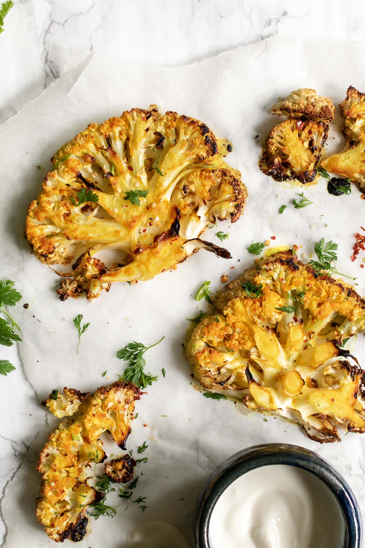 roasted cauliflower steaks on a white background