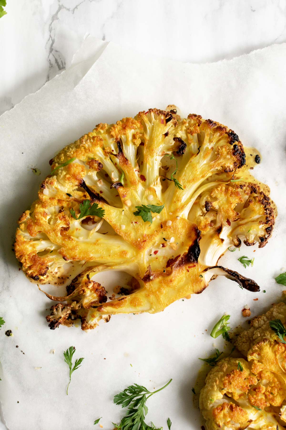 a cauliflower steak topped with fresh coriander