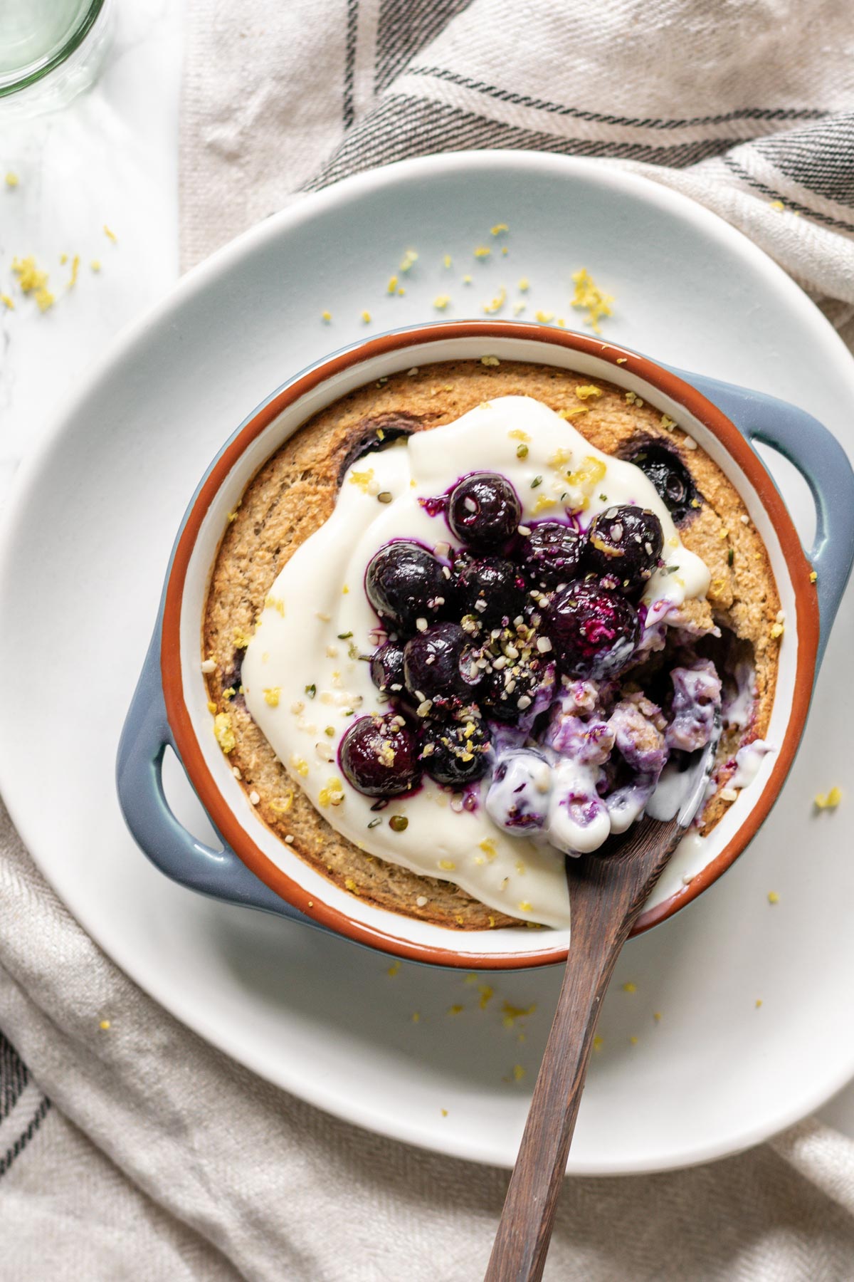 a ramekin of blueberry baked oats being eaten