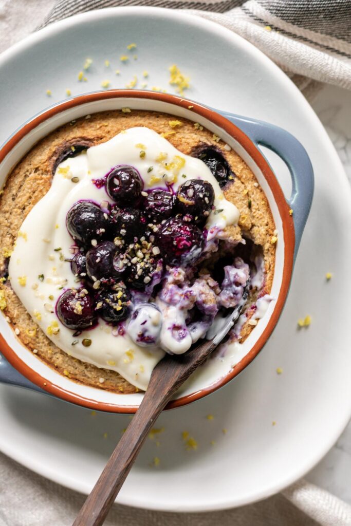 baked oats topped with yoghurt, blueberries and lemon zest