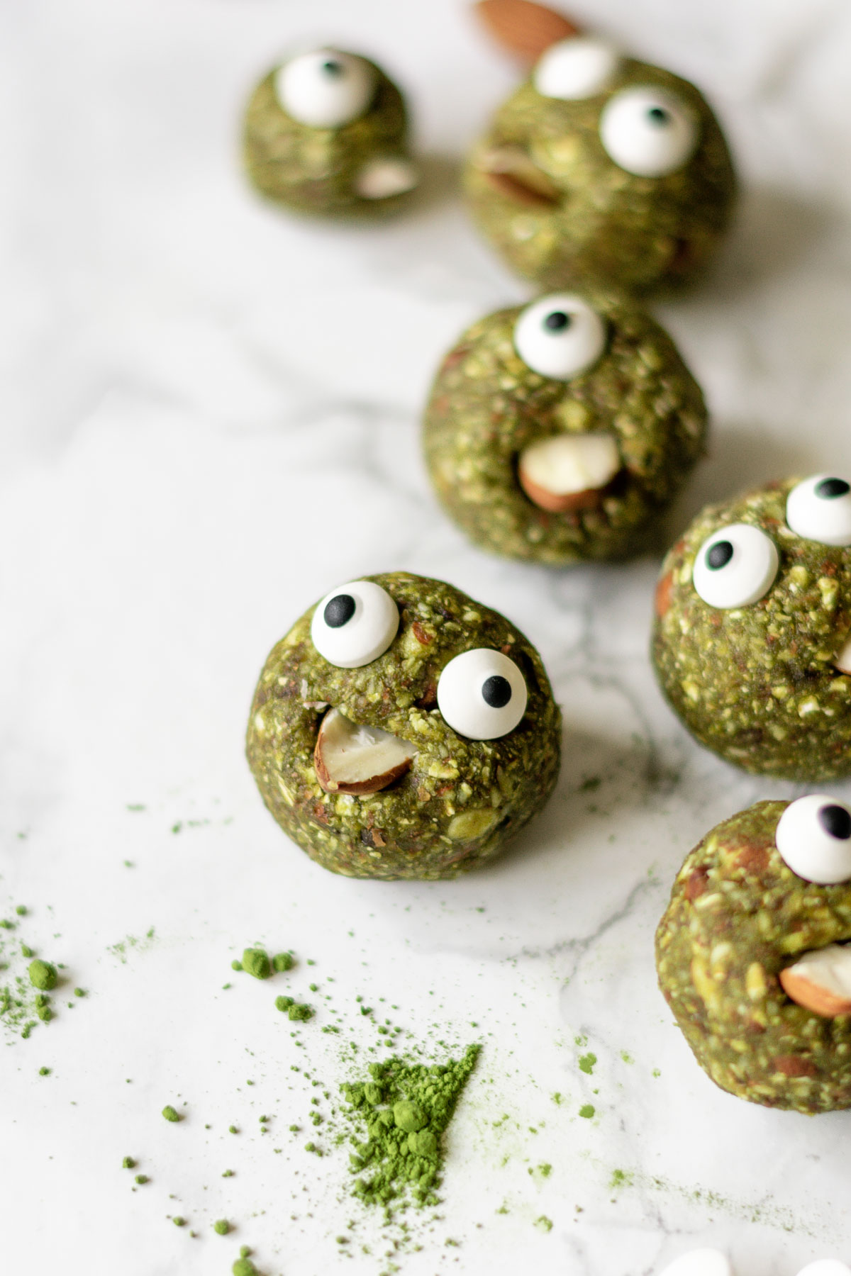 matcha energy balls decorated with eyes and almonds