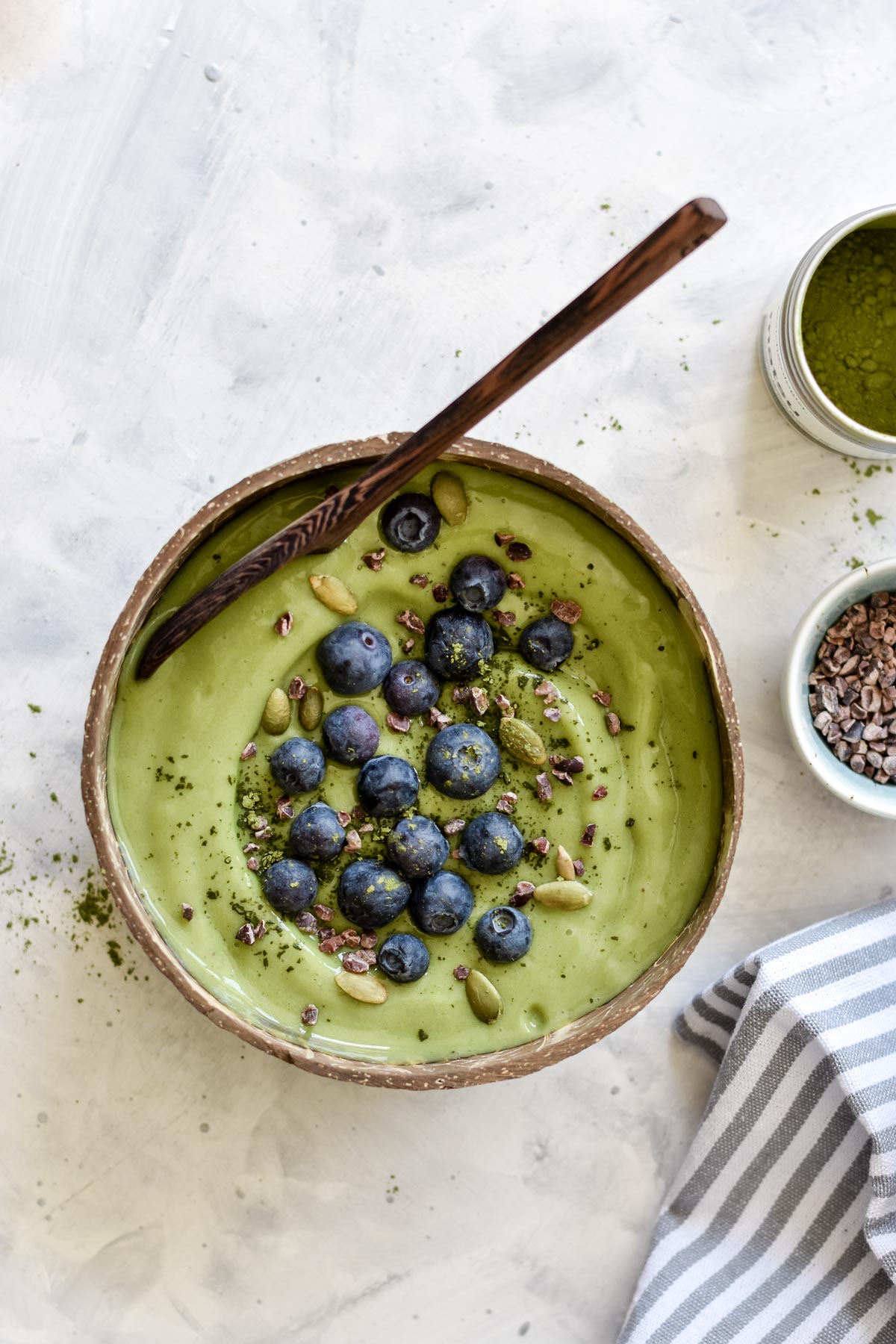 a matcha smoothie bowl with a spoon