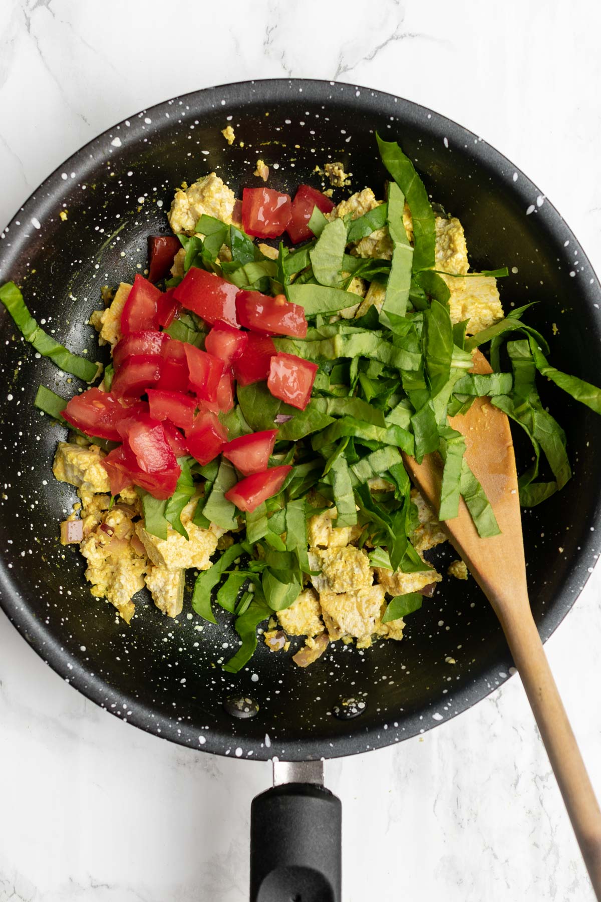 vegetables being added to scrambled tofu