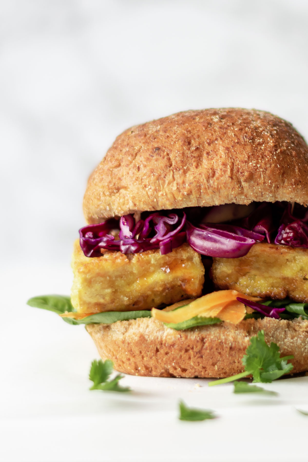 a golden burger with crispy tofu and vegetables