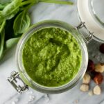 a jar of green vegan pesto