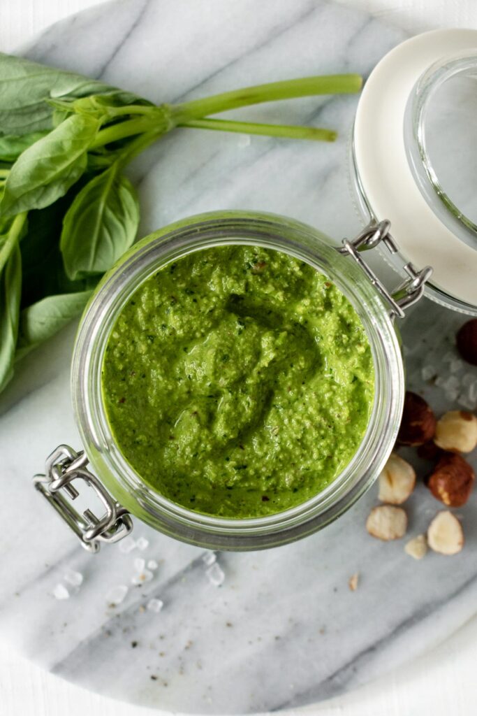a jar of green vegan pesto