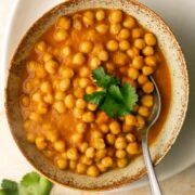 a bowl of chana masala curry with a spoon
