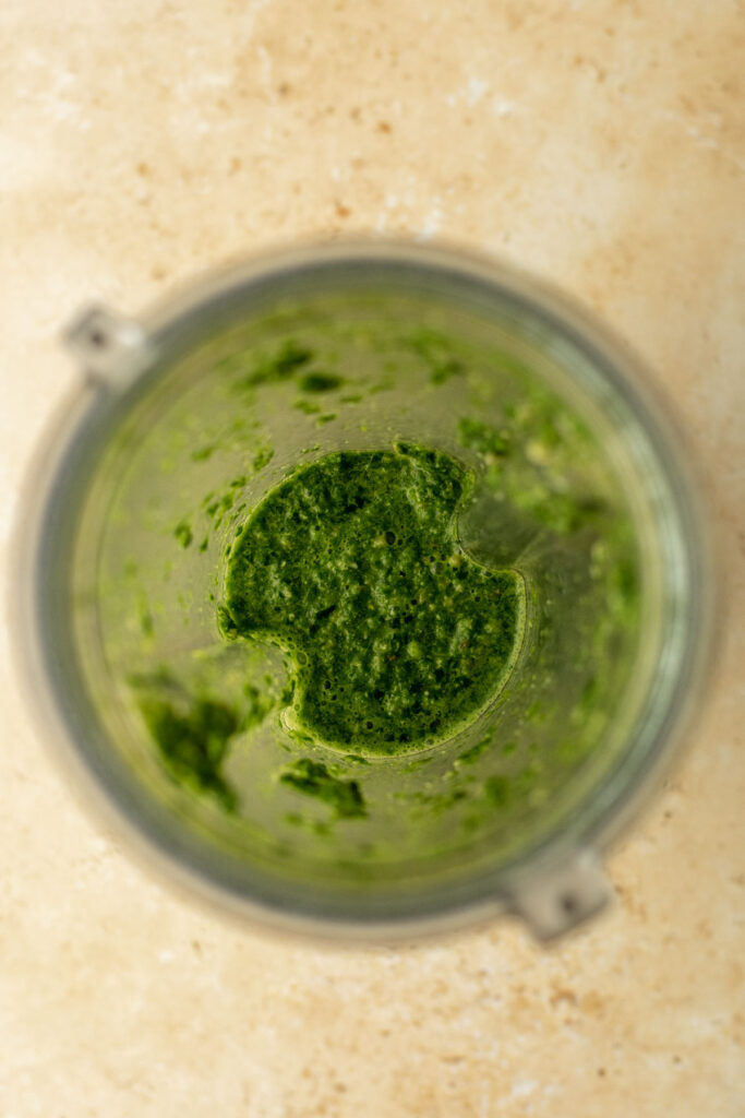 freshly blended coriander chutney in a blender jug showing its slightly coarse texture