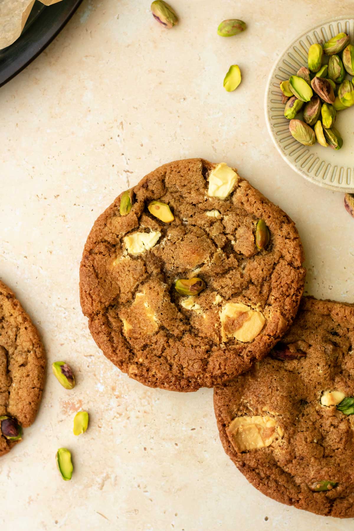 some cookies with white chocolate chunks and whole pistachios