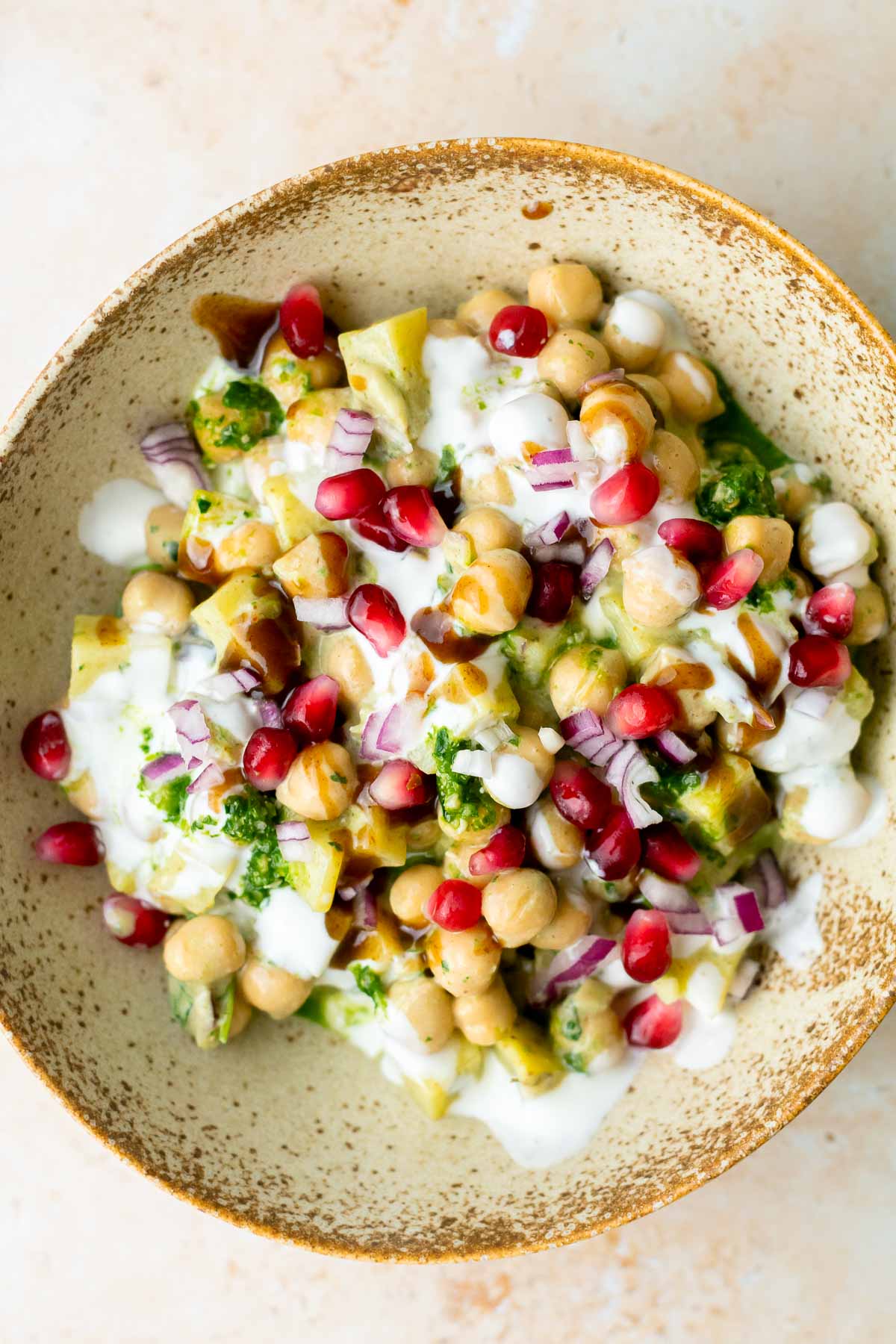 a bowl of chaat topped with pomegranate seeds