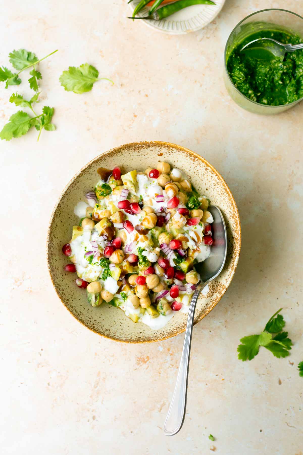 a bowl of chaat with a spoon