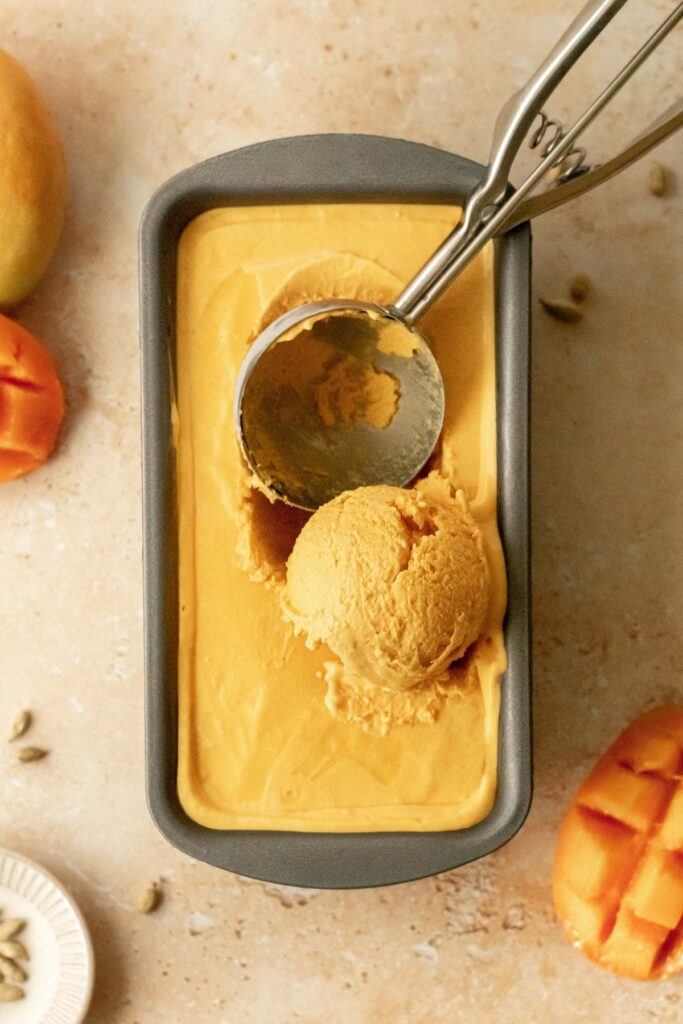 a scoop of mango ice cream in a container