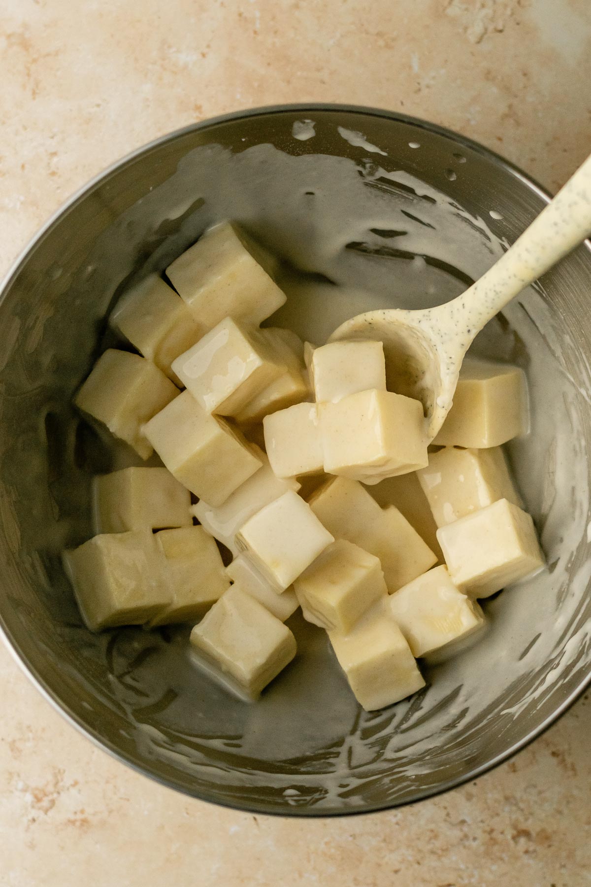 a bowl of paneer cubes tossed in batter