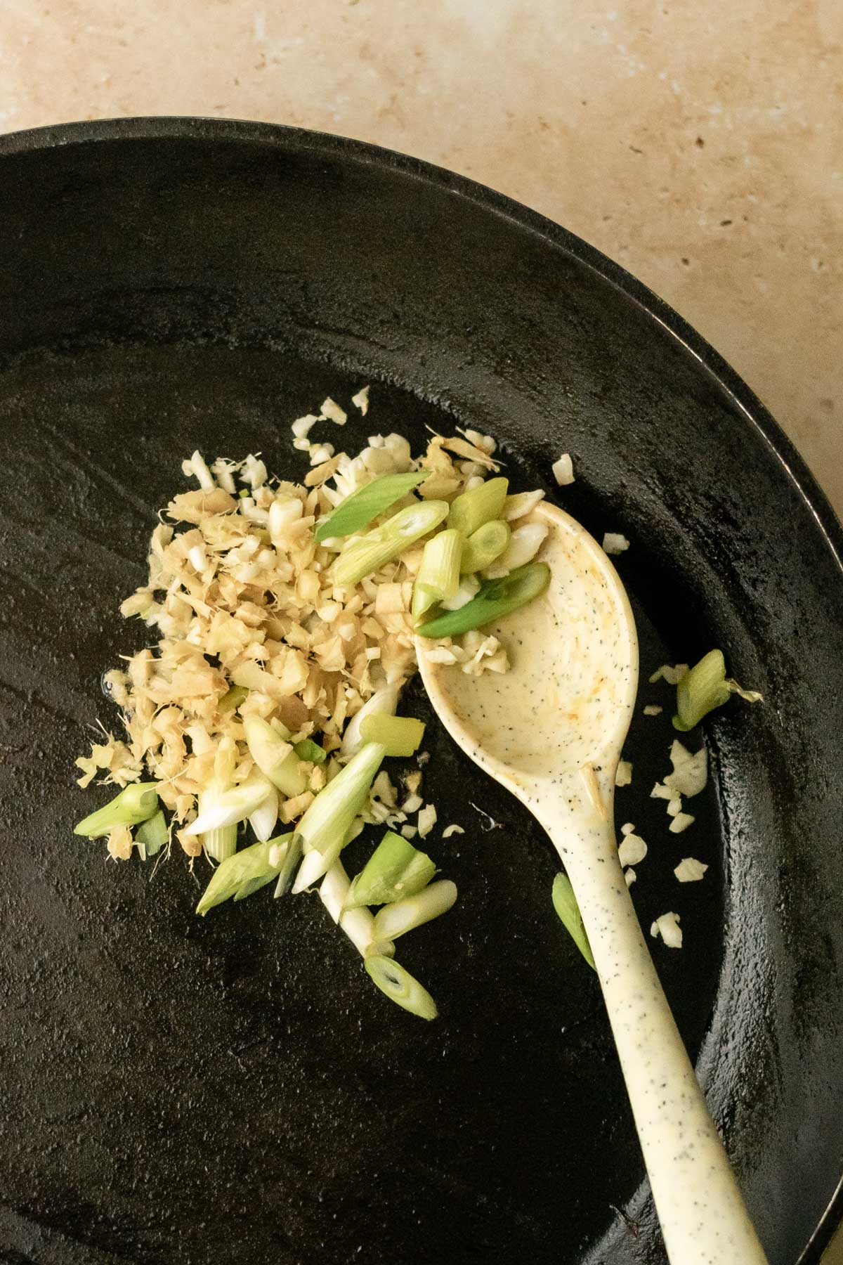 chopped ginger, garlic and spring onion in a frying pan