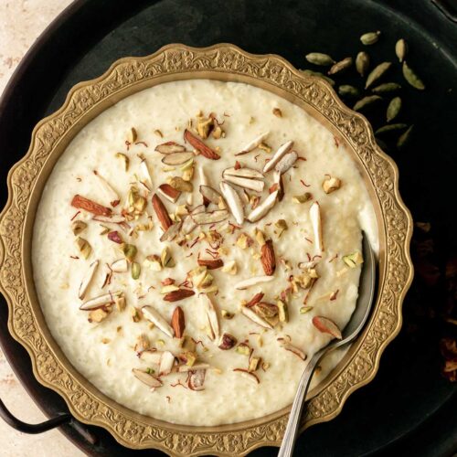 a bowl of kheer garnished with nuts