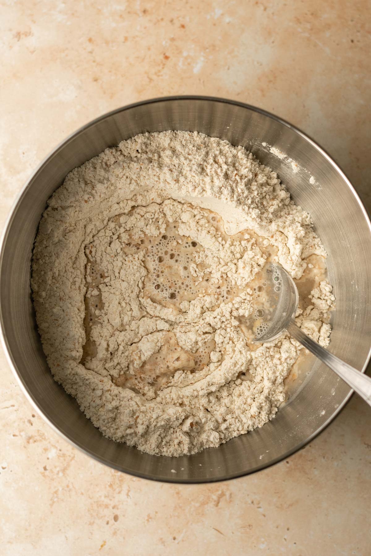 a bowl of flour with some water in it