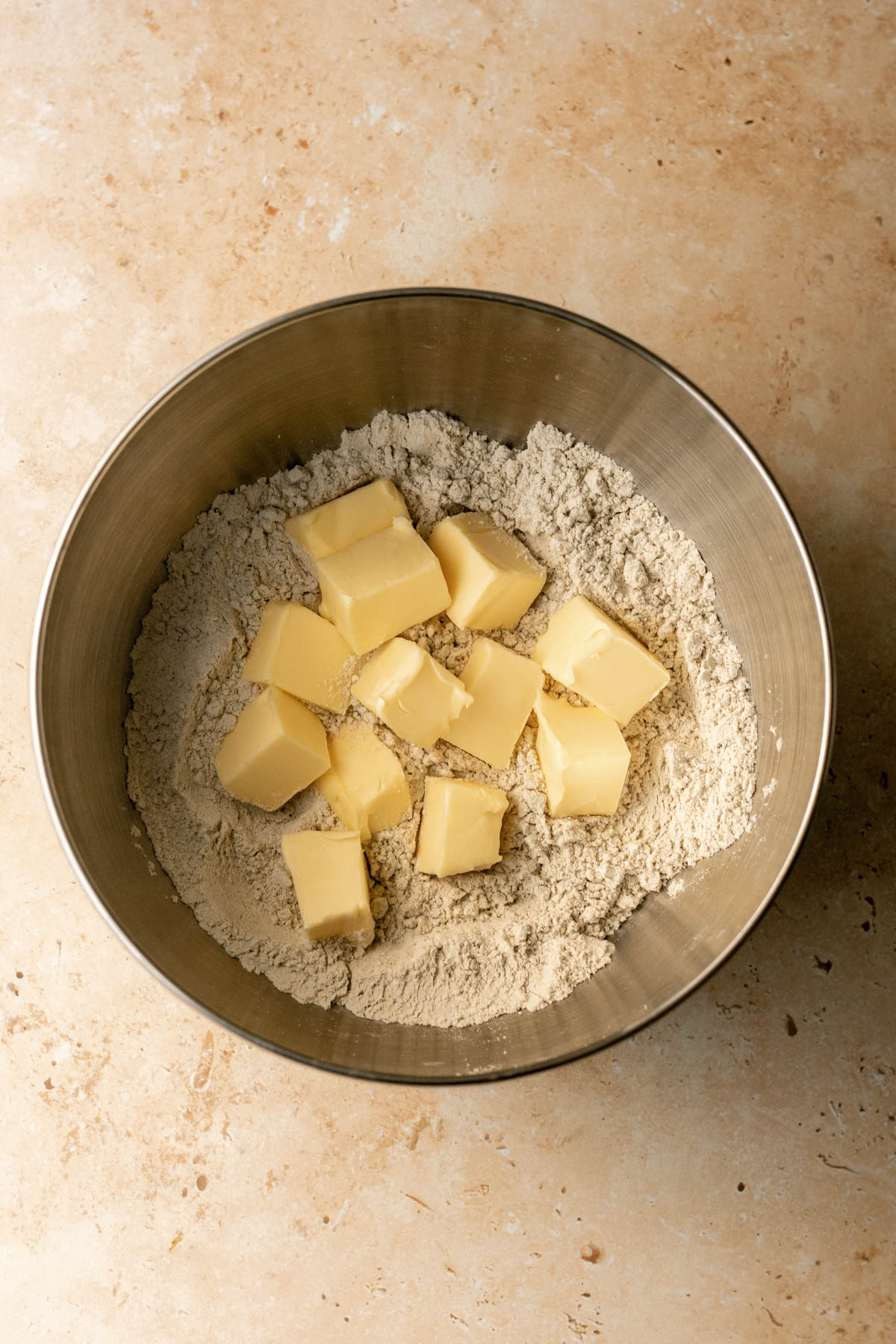 cubes of butter in a bowl of flour and millet flour