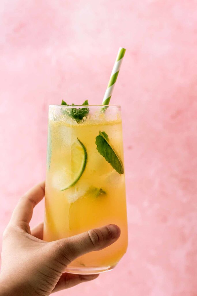 a glass of mocktail being held up